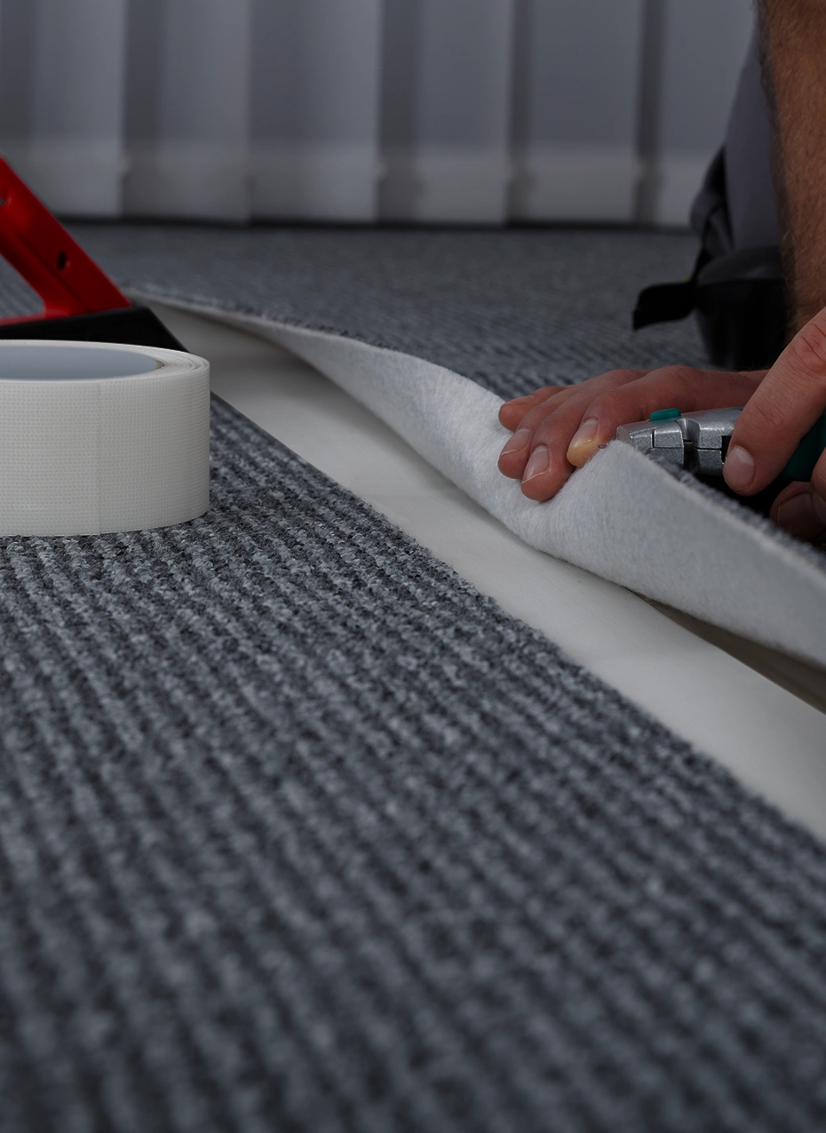 Installing gray carpet on floor